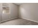 The bedroom features neutral carpeting, and a window for natural light and ventilation at 5656 N 205Th Ln, Buckeye, AZ 85396