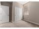 The bedroom includes a window, a door and a closet with white sliding doors at 5656 N 205Th Ln, Buckeye, AZ 85396
