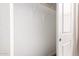 Walk-in closet with wooden rods for hanging storage and white shelving for additional storage at 5656 N 205Th Ln, Buckeye, AZ 85396