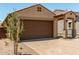 Attractive single-story home featuring a two-car garage, covered entryway, and desert landscaping at 5656 N 205Th Ln, Buckeye, AZ 85396