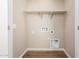 A clean laundry room with tile flooring and hookups for a washer and dryer at 5656 N 205Th Ln, Buckeye, AZ 85396