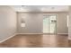 Spacious living room featuring wood-look tile flooring, recessed lighting, and a backyard-facing sliding door at 5656 N 205Th Ln, Buckeye, AZ 85396