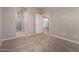 A neutral-toned main bedroom features carpeting and an attached bathroom at 5656 N 205Th Ln, Buckeye, AZ 85396