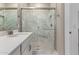 A glass walk-in shower with sleek fixtures and finishes and marble tiling at 5656 N 205Th Ln, Buckeye, AZ 85396