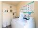 This laundry room features several commercial washing machines with posted instructions and provided supplies at 1136 N 84Th Pl, Scottsdale, AZ 85257