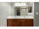 Double vanity bathroom with wood cabinets and mirror at 23559 W Wayland Dr, Buckeye, AZ 85326