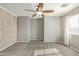 Simple bedroom with wood-like accent wall and carpet at 23559 W Wayland Dr, Buckeye, AZ 85326