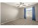 Well-lit bedroom featuring a ceiling fan and window at 23559 W Wayland Dr, Buckeye, AZ 85326