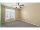 Spacious bedroom with large window and ceiling fan at 23559 W Wayland Dr, Buckeye, AZ 85326