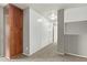 Spacious hallway with neutral colored walls and carpet at 23559 W Wayland Dr, Buckeye, AZ 85326