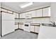 White kitchen with wood cabinets and tile floor at 4723 N 84Th Ln, Phoenix, AZ 85037