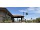 The clubhouse has a beautiful desert landscape with multiple cacti, palm trees, and a building entrance at 25609 N Forest Rd # 13, Rio Verde, AZ 85263