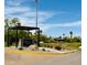 Community entrance sign with lush landscaping, trees, and desert plants at 25609 N Forest Rd # 13, Rio Verde, AZ 85263