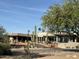 Exterior view of a well-maintained building with desert landscaping, featuring native cacti and trees at 25609 N Forest Rd # 13, Rio Verde, AZ 85263