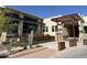 Exterior of building showing architectural details, desert landscaping, and concrete walkway at 25609 N Forest Rd # 13, Rio Verde, AZ 85263