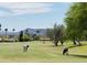 Scenic golf course showcasing green fairways, mature trees, and mountain views in the background at 25609 N Forest Rd # 13, Rio Verde, AZ 85263