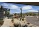 Scenic desert landscape with palm trees, cacti, and views of distant mountains under a partly cloudy sky at 25609 N Forest Rd # 13, Rio Verde, AZ 85263