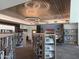 Library with bookshelves filled with reading material, modern lighting, and comfortable seating at 25609 N Forest Rd # 13, Rio Verde, AZ 85263