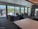 Inviting lounge area with comfortable seating and expansive windows overlooking the golf course at 25609 N Forest Rd # 13, Rio Verde, AZ 85263