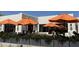 Outdoor seating area with orange umbrellas providing shade for the restaurant at this property at 25609 N Forest Rd # 13, Rio Verde, AZ 85263