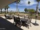 Outdoor patio dining area with picturesque views of the lush golf course and palm trees at 25609 N Forest Rd # 13, Rio Verde, AZ 85263