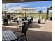 Outdoor patio dining area with tables, chairs, umbrellas and heaters at 25609 N Forest Rd # 13, Rio Verde, AZ 85263