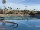 Community swimming pool surrounded by chaise lounges and lush landscaping with clear blue sky in the background at 25609 N Forest Rd # 13, Rio Verde, AZ 85263