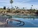 Community swimming pool surrounded by chaise lounges and lush landscaping with clear blue sky in the background at 25609 N Forest Rd # 13, Rio Verde, AZ 85263