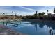 Community swimming pool surrounded by chaise lounges and lush landscaping with clear blue sky in the background at 25609 N Forest Rd # 13, Rio Verde, AZ 85263