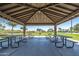 Park pavilion with picnic tables under a shaded roof at 30080 W Fairmount Ave, Buckeye, AZ 85396