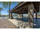 Park pavilion with stone pillars and picnic tables at 30080 W Fairmount Ave, Buckeye, AZ 85396