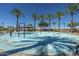 Splash pad with water features surrounded by palm trees at 30080 W Fairmount Ave, Buckeye, AZ 85396