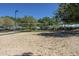 Outdoor sand volleyball court with net and surrounding trees at 30080 W Fairmount Ave, Buckeye, AZ 85396