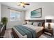 Relaxing bedroom with neutral tones, cozy bedding, and a large window with blinds at 8828 S 167Th Ln, Goodyear, AZ 85338