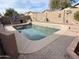 Enjoy a relaxing day in this backyard featuring a sparkling pool, outdoor kitchen and lots of lounge space at 12742 W Ash St, El Mirage, AZ 85335