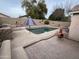 Private backyard pool featuring custom outdoor kitchen and fireplace is perfect for enjoying sunny days and evenings at 12742 W Ash St, El Mirage, AZ 85335