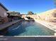 Enjoy a relaxing afternoon in the backyard pool, surrounded by lush greenery and a beautiful sunny sky at 12742 W Ash St, El Mirage, AZ 85335