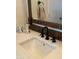 Bathroom vanity sink with black faucet fixtures, white counter, and silver decorative accessories at 12742 W Ash St, El Mirage, AZ 85335