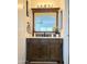 Bathroom vanity with wood cabinets, white countertop, decorative mirror, and traditional-style fixtures at 12742 W Ash St, El Mirage, AZ 85335