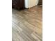Wood-look tile flooring adjacent to furnishings in this home at 12742 W Ash St, El Mirage, AZ 85335