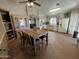 Eat-in kitchen with tile floors, light wood cabinets, stainless steel appliances, and dining table at 12742 W Ash St, El Mirage, AZ 85335