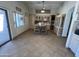 Eat-in kitchen with tile floors, light wood cabinets, stainless steel appliances, and dining table with 2 chairs at 12742 W Ash St, El Mirage, AZ 85335
