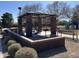 View of the park's covered picnic area, equipped with a grill and seating, surrounded by landscaping at 12742 W Ash St, El Mirage, AZ 85335