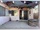 Covered patio with fun ceiling art, a fire pit, and access to the home at 12742 W Ash St, El Mirage, AZ 85335