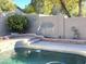 Inviting backyard pool area featuring decorative wall art, lush greenery, and well-maintained landscaping at 12742 W Ash St, El Mirage, AZ 85335