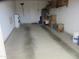 Attached garage space with dirty concrete floors, boxes for storage and shelving units at 1881 E Kerby Farms Rd, Chandler, AZ 85249