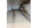 Attached garage space with dirty concrete floors, boxes for storage and shelving units at 1881 E Kerby Farms Rd, Chandler, AZ 85249