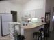 Well-maintained kitchen with white cabinets, appliances, and breakfast bar at 1881 E Kerby Farms Rd, Chandler, AZ 85249