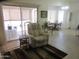 Open living space with a floral recliner, sliding glass doors to sunroom, and dining table at 1881 E Kerby Farms Rd, Chandler, AZ 85249