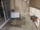 A cozy screened-in patio features a rocking chair, small table, and pleasant decor at 1881 E Kerby Farms Rd, Chandler, AZ 85249
